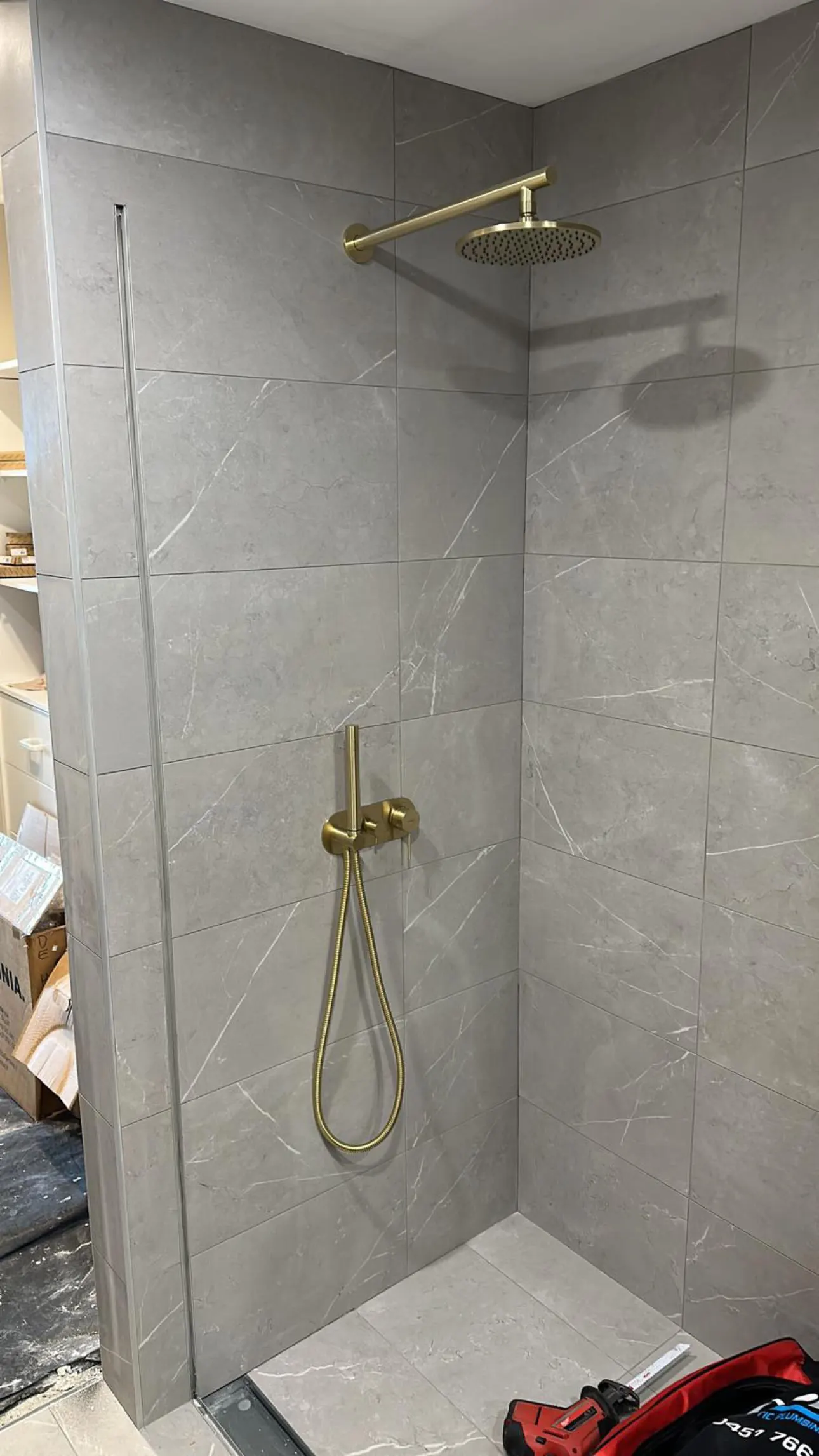 Brass shower mixer installed by OPS in marble Inner West bathroom