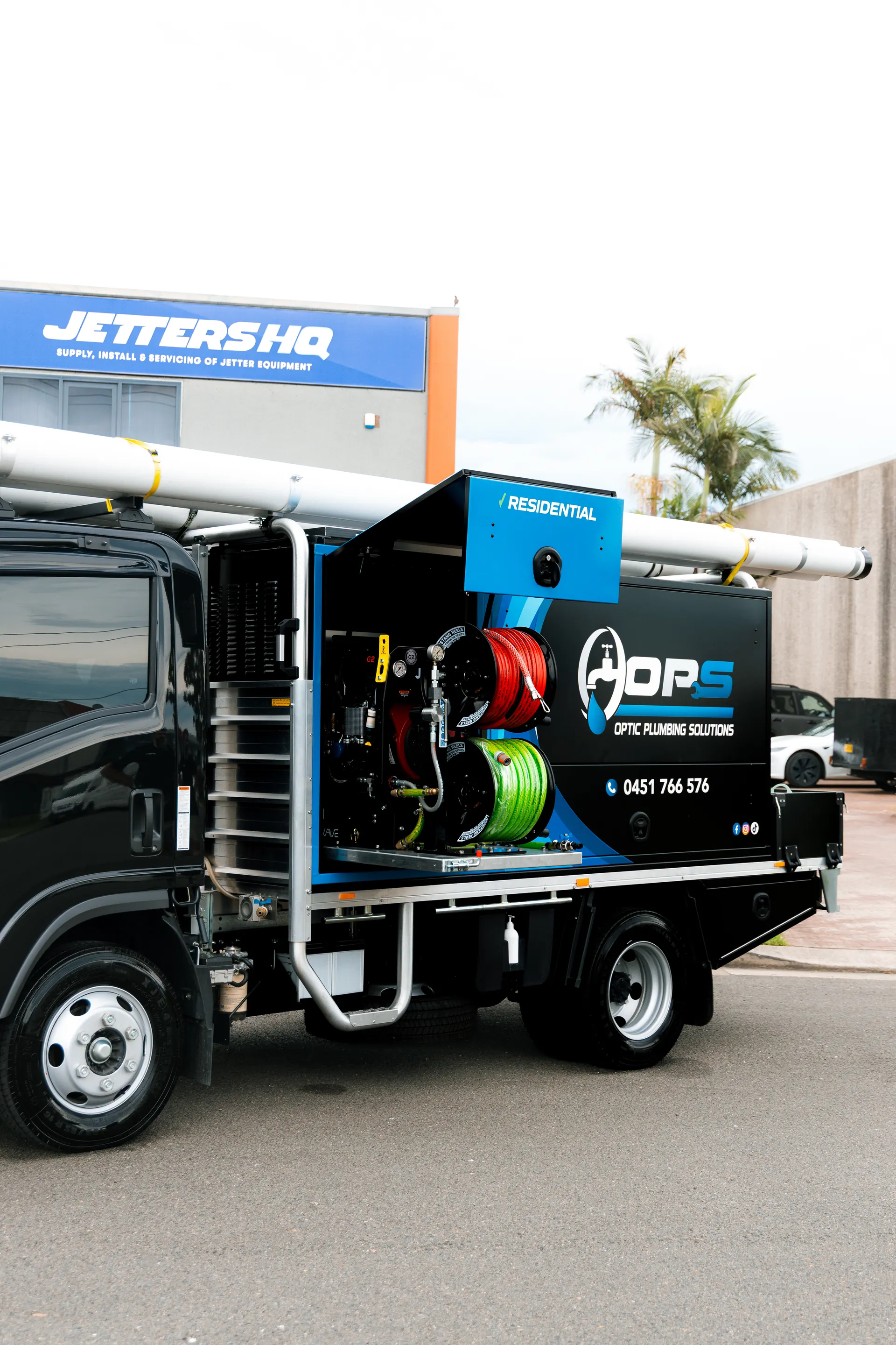OPS service truck side view — full residential jet blasting unit on board